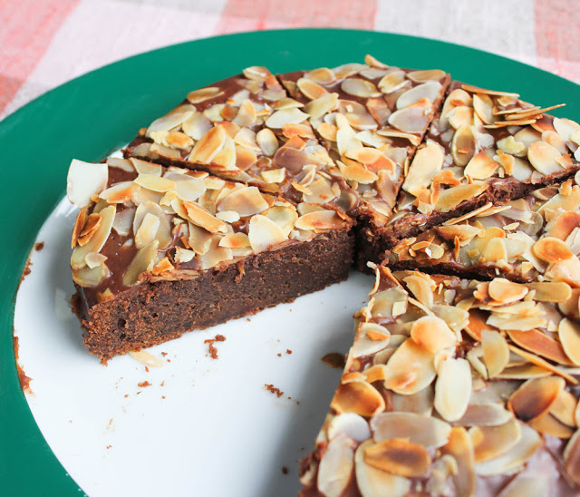 freshly cut chocolate cake with almonds